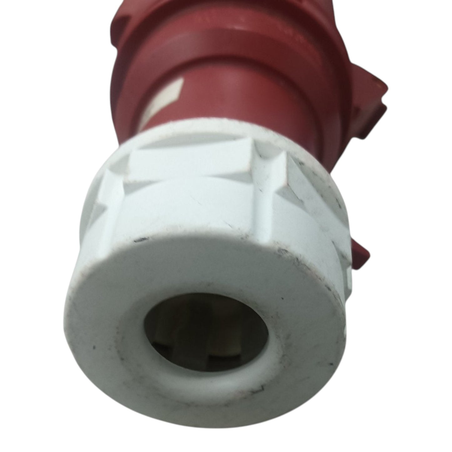 Close-up of a red and white valve or connector on a white background