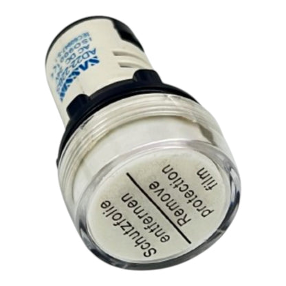 A cylindrical automotive light component with a clear outer lens, white interior, and black top section. The front label reads 'Schutzolie entfernen' and 'Remove protection film' in black text, with blue text on the side.