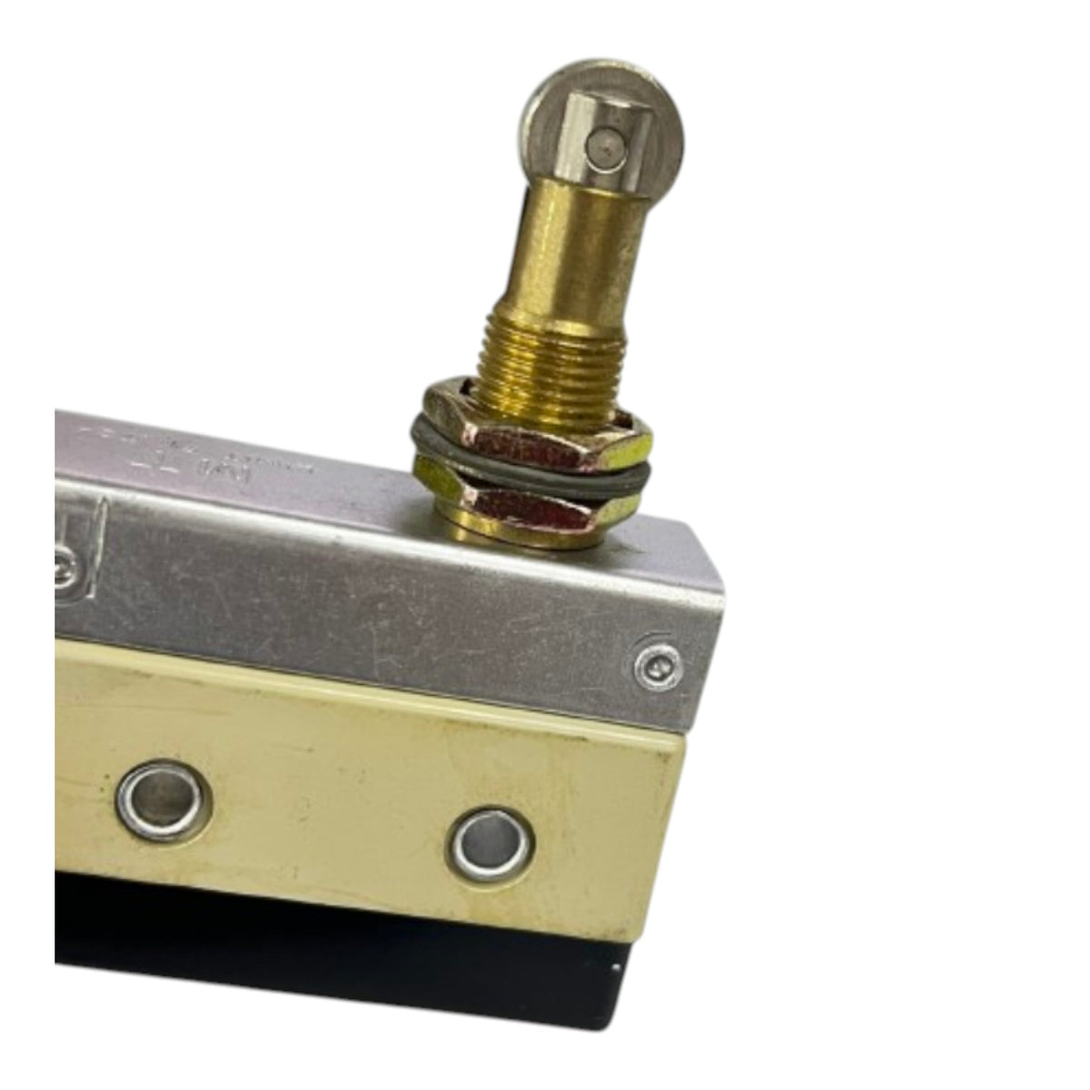 A close-up of a brass toggle switch with a hex nut and washer, mounted on a metal and brass switch block with a black base, on a white background.
