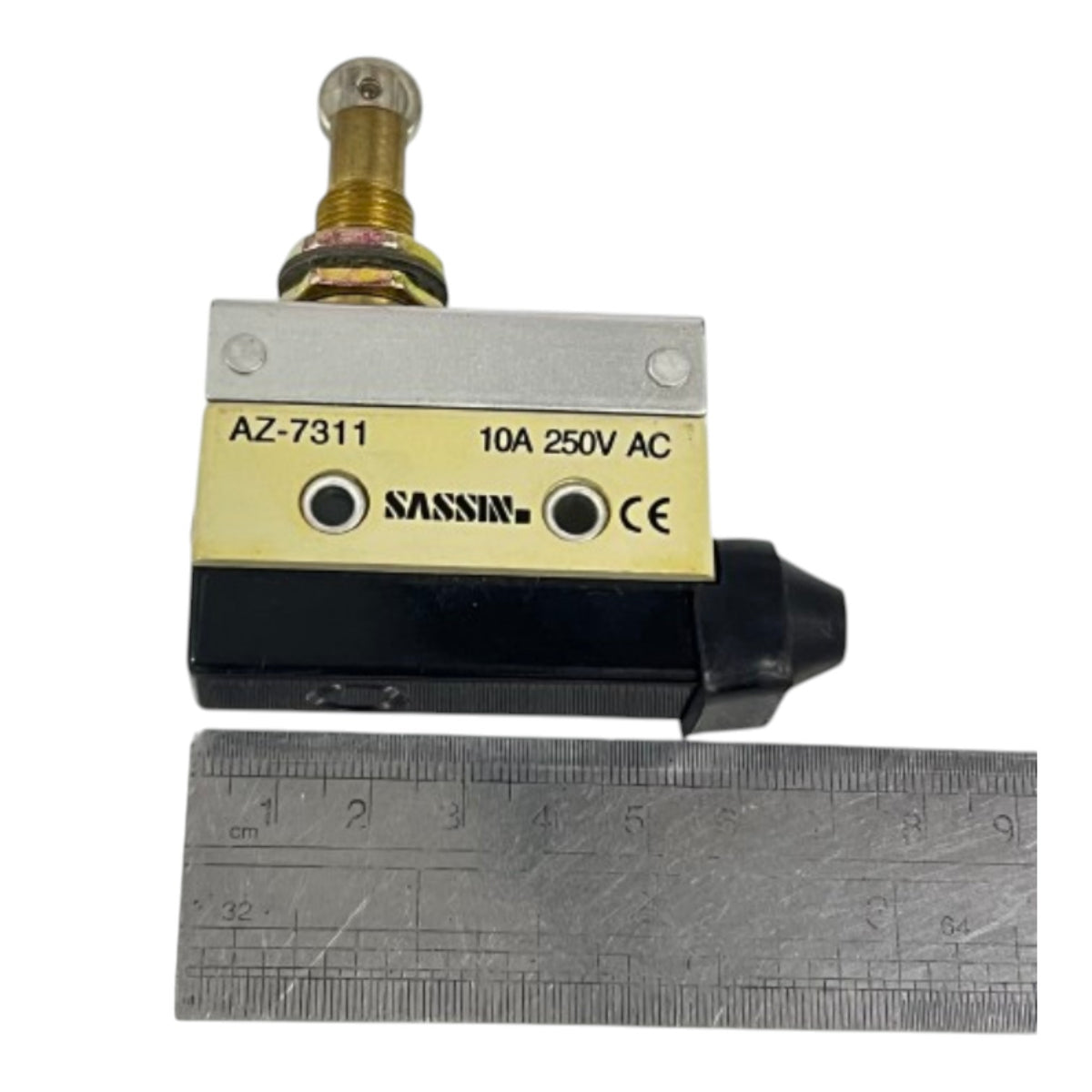 A SASSIN AZ-7311 AC contactor relay with a black and silver body, a brass terminal, and a yellow nameplate, shown next to a metal ruler for scale.
