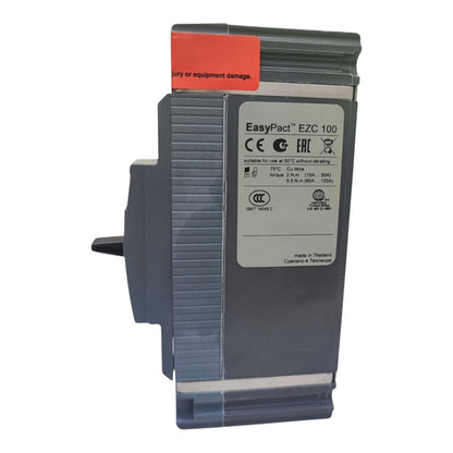 EasyPact EZC 100 electrical module in dark gray plastic with a white label and a red warning sticker, shown on a plain white background.