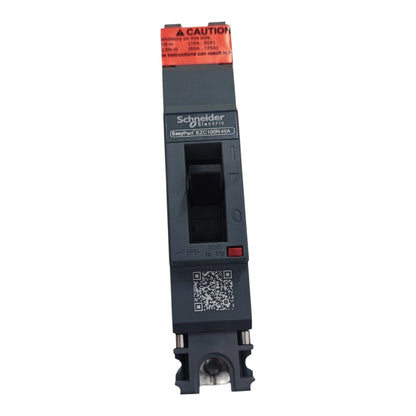 Schneider Electric ELCIA EAC100L60A modular electrical contactor module, featuring a dark gray body, an orange top warning label, and a black central terminal block, shown on a plain white background.