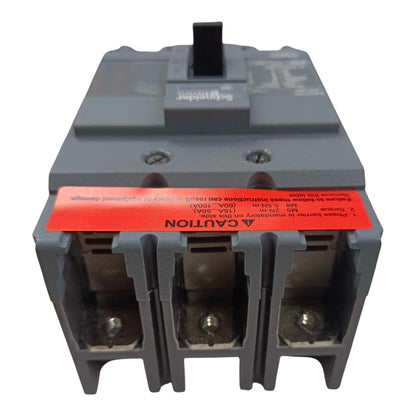 A gray electrical circuit breaker with a prominent red caution label on the front, photographed against a plain white background.