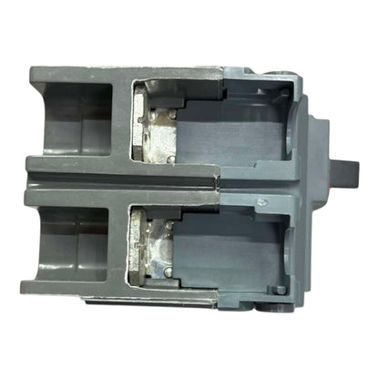 A gray plastic mechanical component or housing with a cutaway view showing internal structure, isolated on a white background.