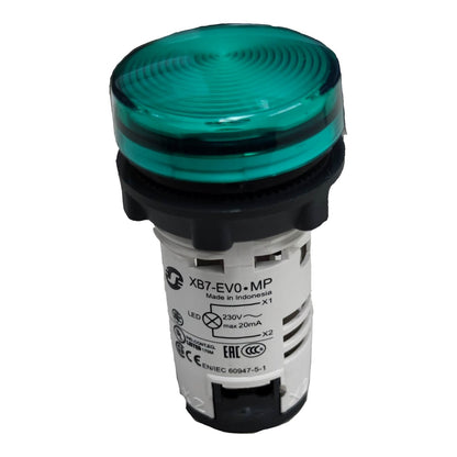 An industrial push-button indicator light with a translucent green lens, black plastic base, and a white label showing technical specifications.