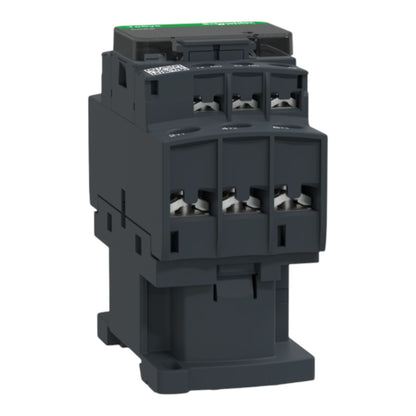A dark gray industrial electrical contactor with a green top label, shown on a solid white background.