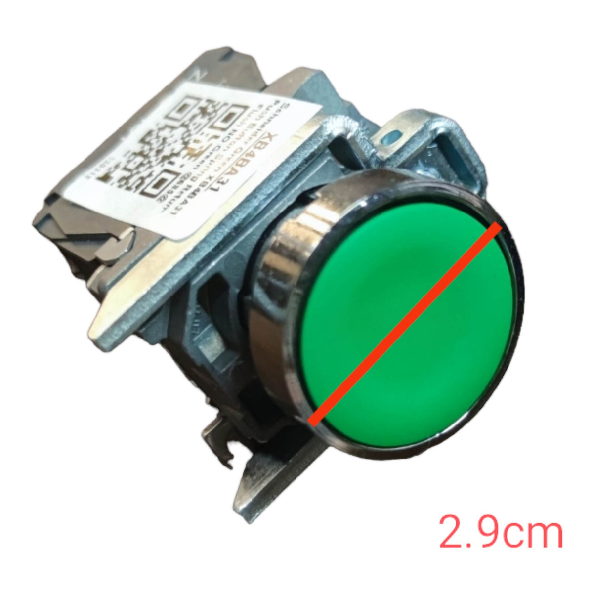 A metal industrial push button with a round green face and a red diagonal measurement line across it, with '2.9cm' text in red at the bottom right, on a white background.