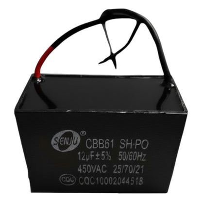 Black capacitor with red lead wire on a white background