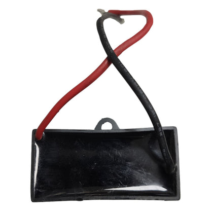 Black rectangular component with red and black wires on a white background