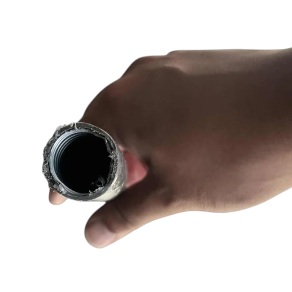 A close-up of a hand holding the open end of a metal pipe or hose fitting against a plain white background.
