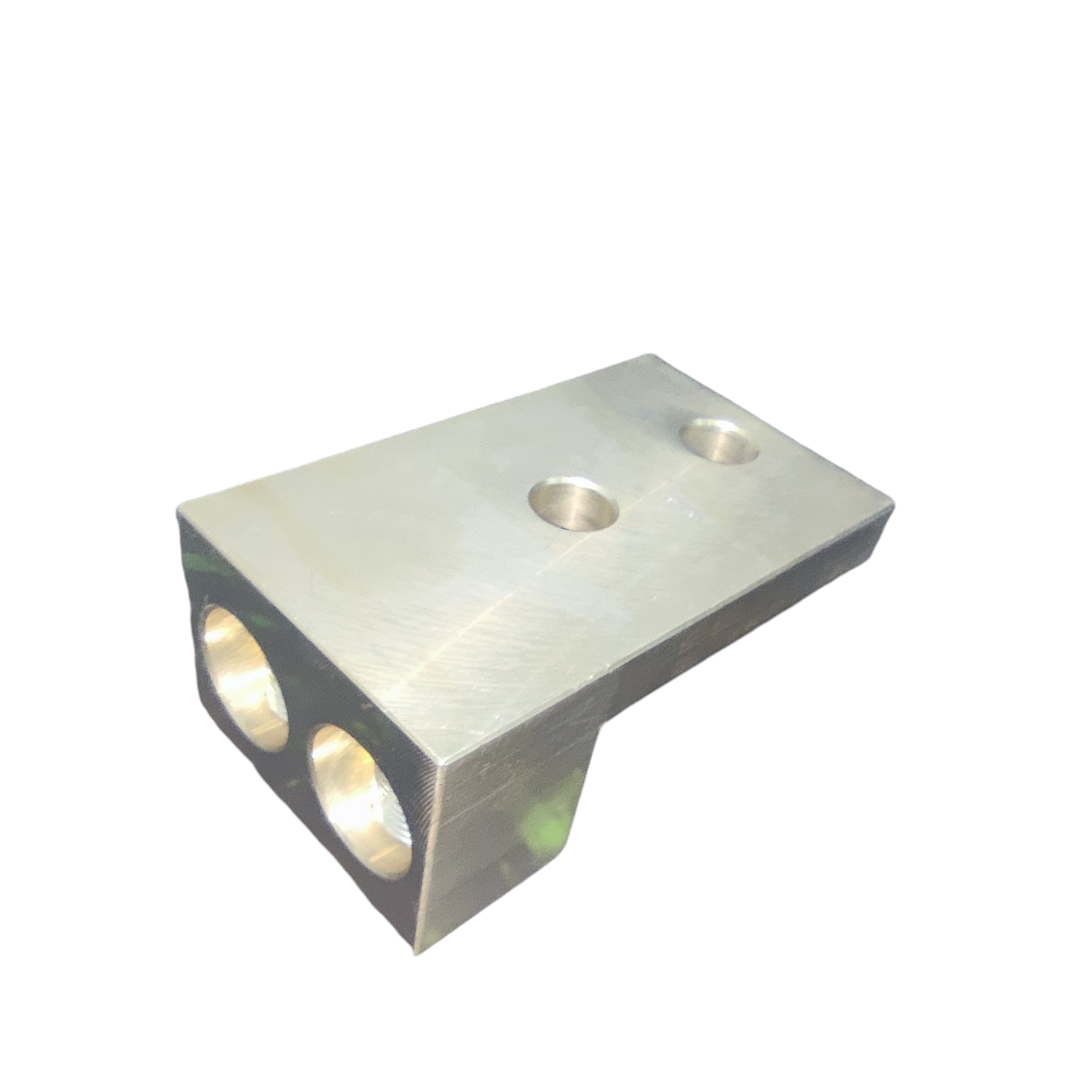 Metallic block with three circular holes on a white background