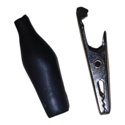 A black rubber alligator clip shown next to its silver metal spring-loaded counterpart on a plain white background.