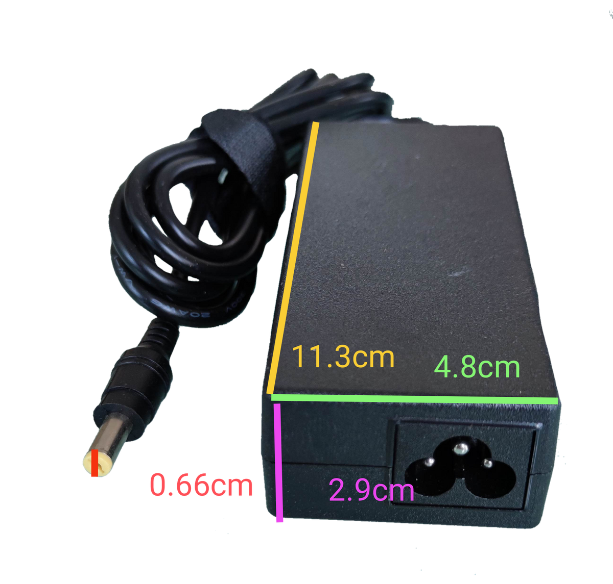 Sony laptop power supply with black rectangular adapter and attached cable on black background