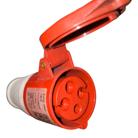 A red three-pin electrical outlet connector with a hinged protective cover open, shown on a plain white background.