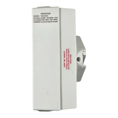 A white plastic wall-mounted water filter assembly with printed installation instructions and red warning text on the front, shown against a plain white background.