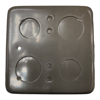 A square dark gray plastic cover with four circular cutouts and several small screw holes, shown against a plain white background.