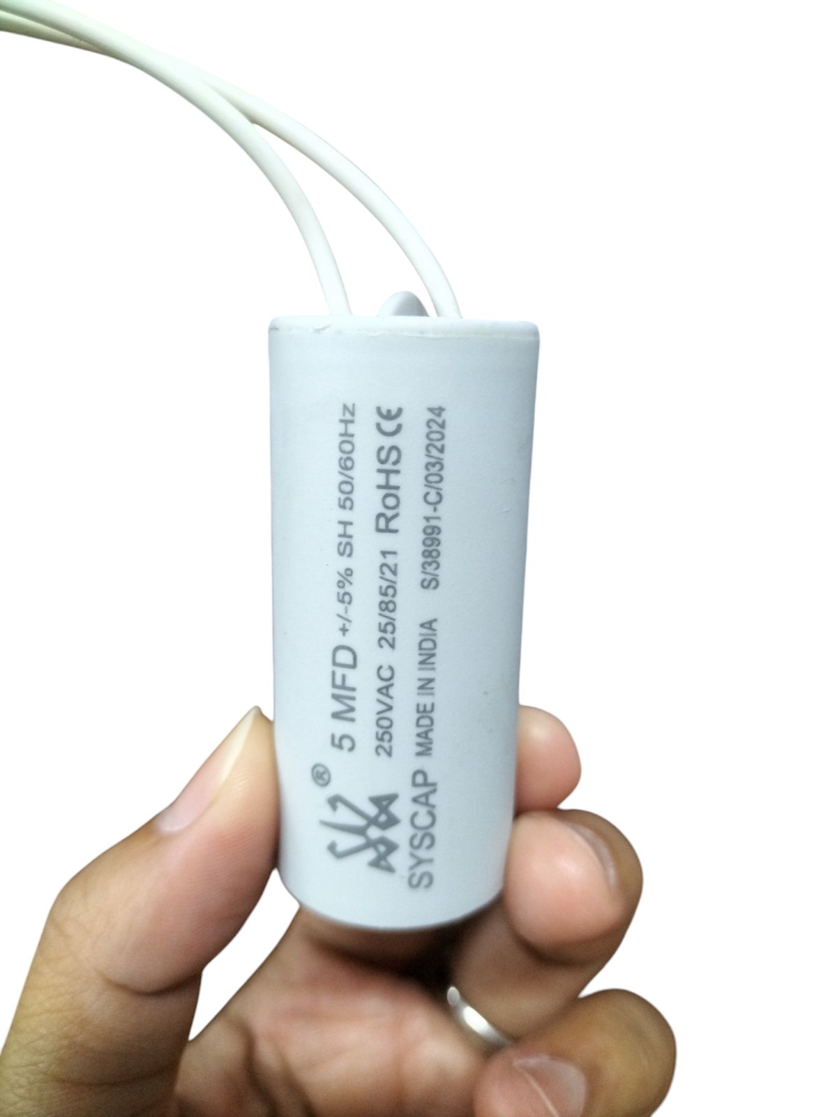 Syscap High Quality 5 MFD 250V Capacitor held by hand for electrical circuitry use