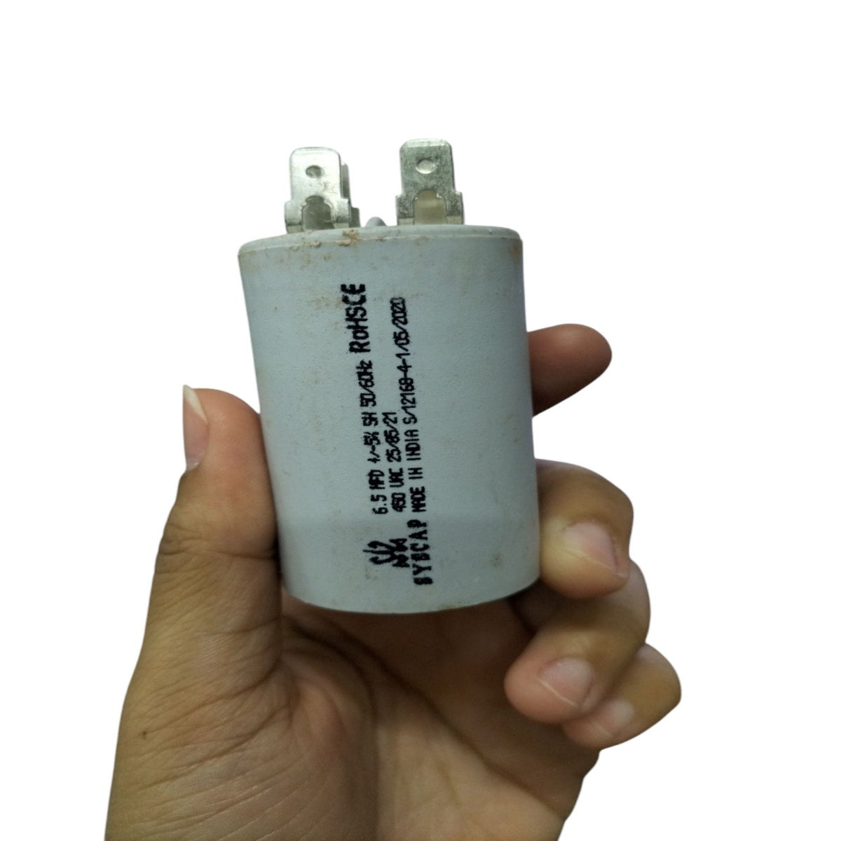 Syscap Motor Running Capacitor 450V held in hand, designed for electrical circuit applications