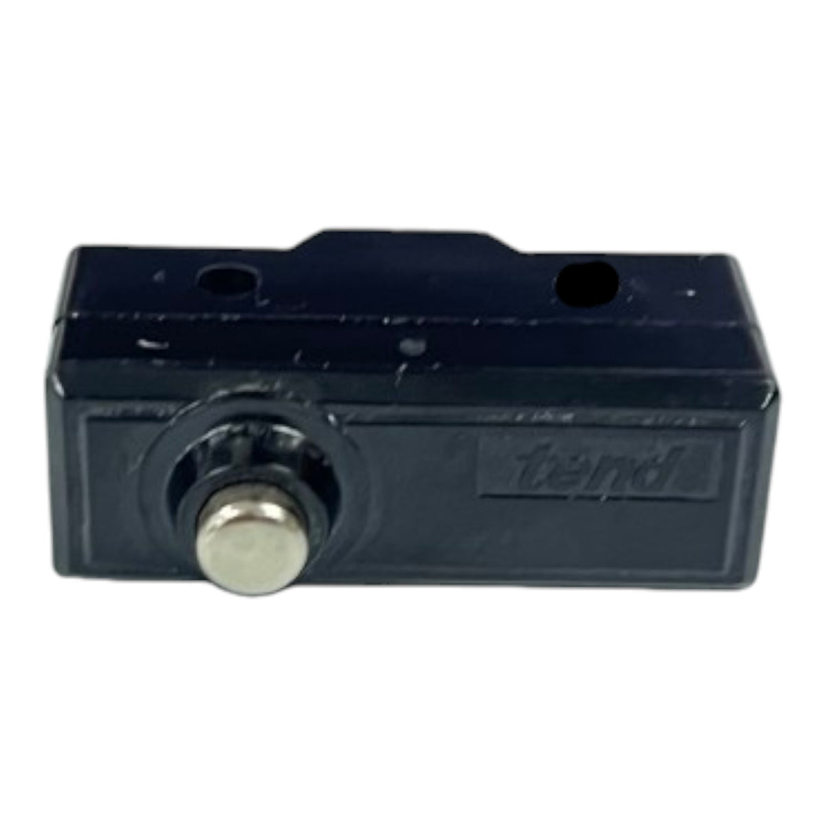 A black plastic lockout switch module with a silver metal button and a debossed 'trend' brand logo on the side, shown against a plain white background.