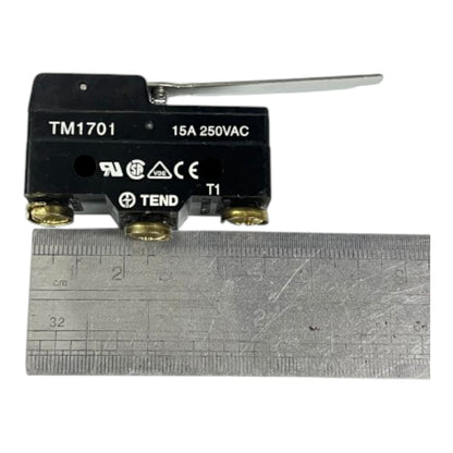 A black 15A 250VAC thermal relay switch with a silver lever and brass terminals, shown above a metal ruler for scale on a white background.