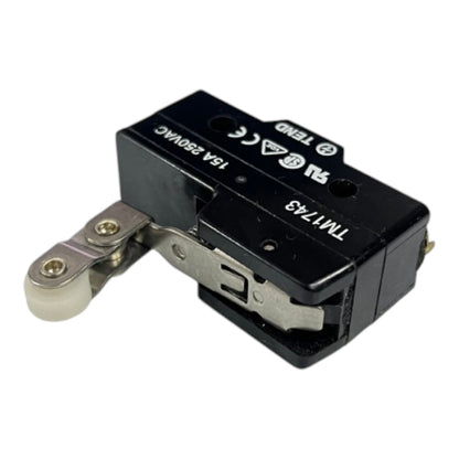 A black electrical contact switch with a silver metal lever and a small white roller, featuring printed specifications and certification logos on its top surface.
