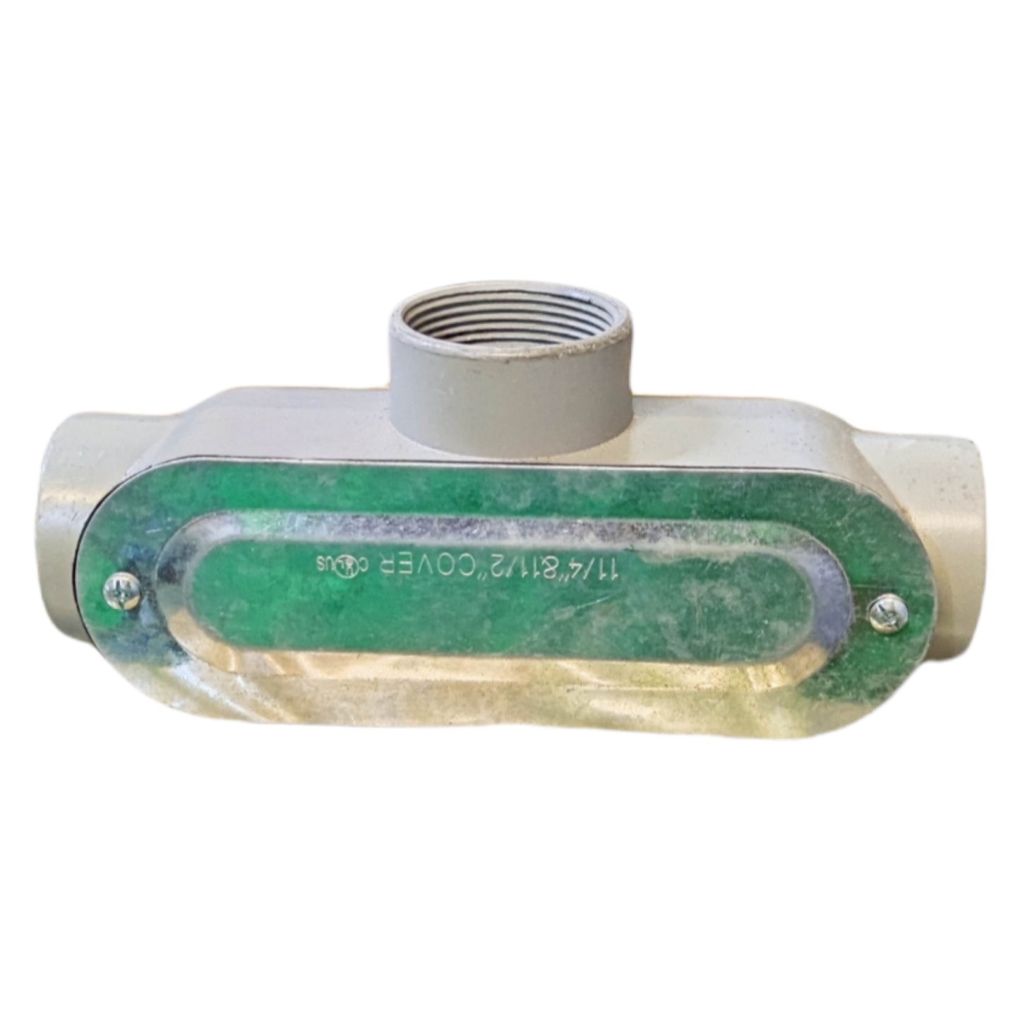 Metal fitting with green label on a white background