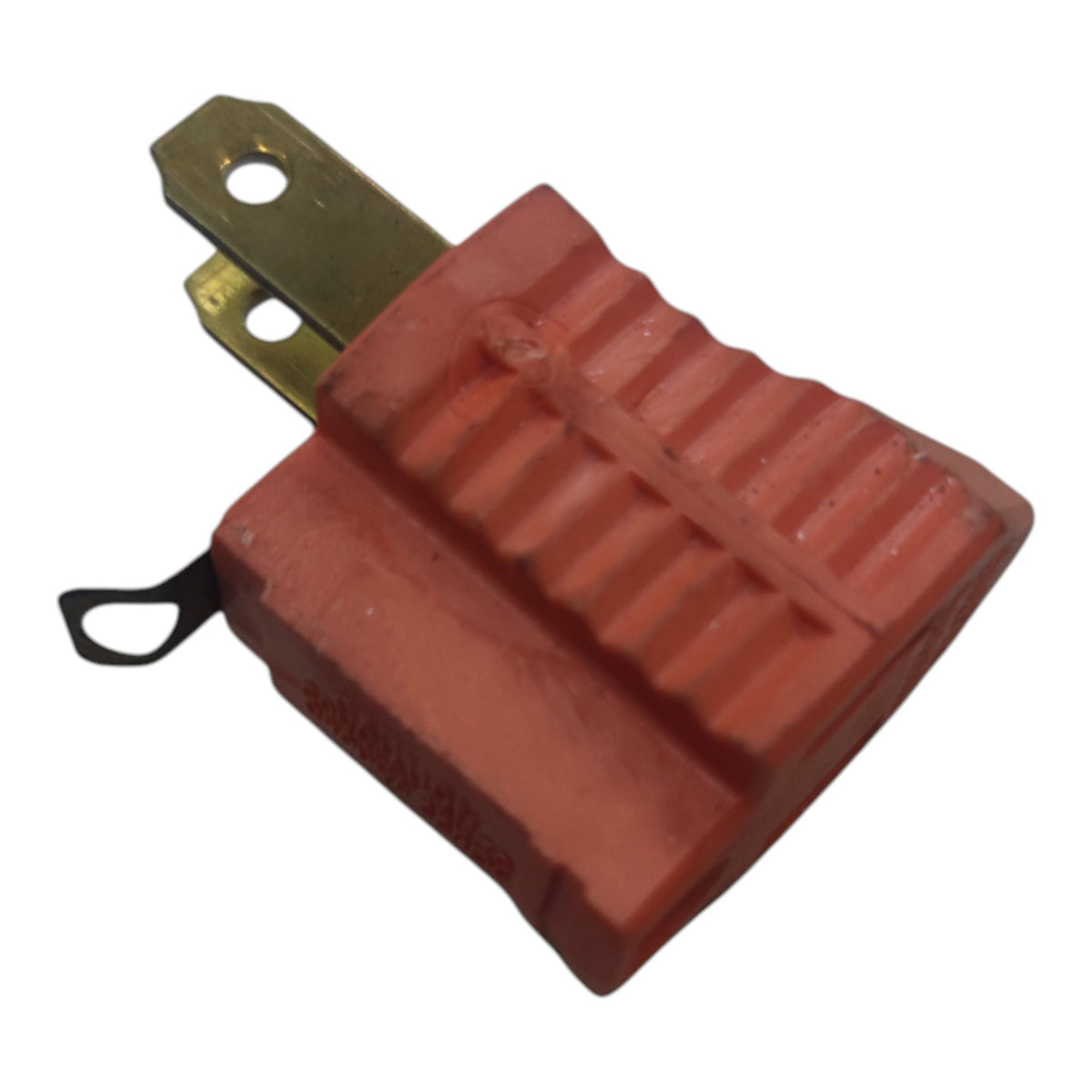 A red molded plastic electrical connector with a brass metal terminal and a small black loop tag, shown on a plain white background.