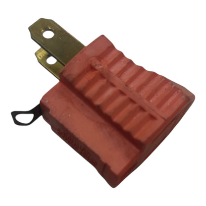 A red molded plastic electrical connector with a brass metal terminal and a small black loop tag, shown on a plain white background.