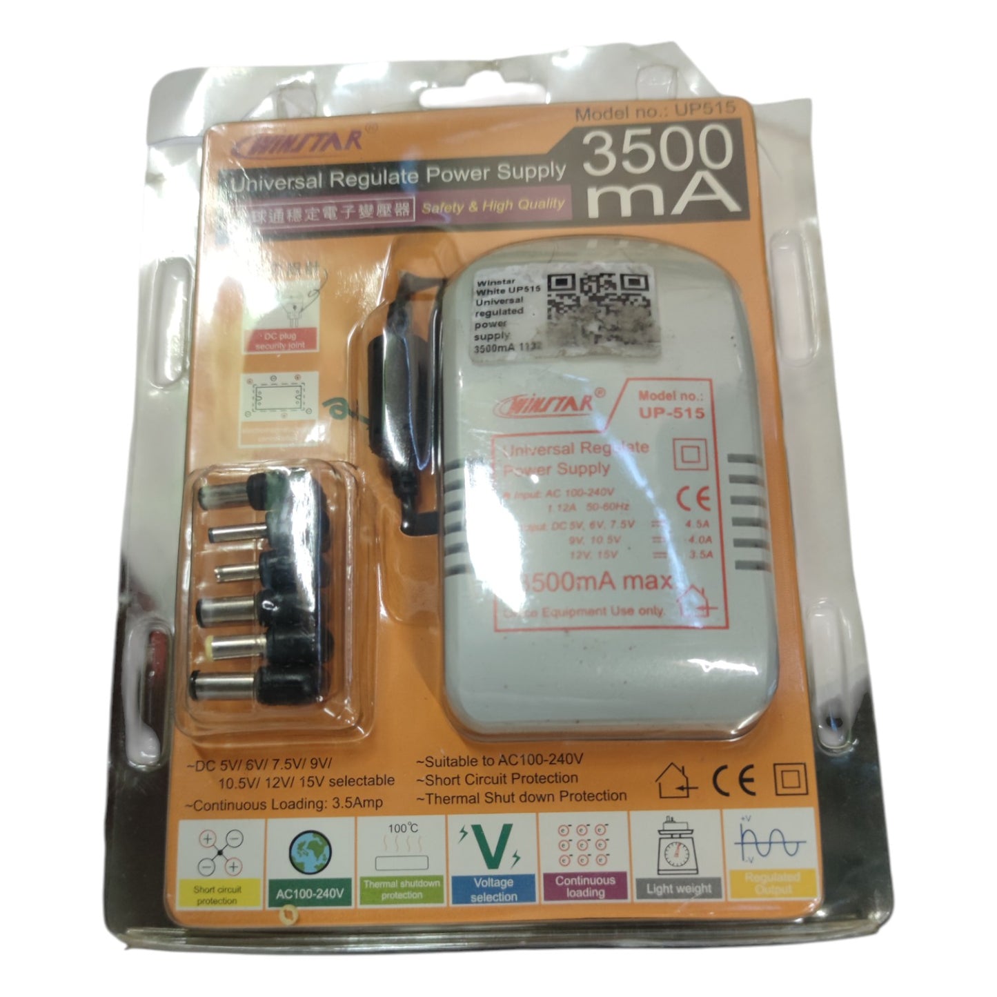 Universal regulate power supply with accessories in packaging on a white background