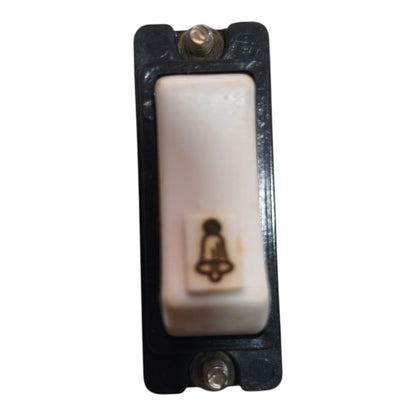 A single-button push-to-call or alarm switch with a white ceramic button and a black plastic housing, featuring a small printed bell icon on the button face.