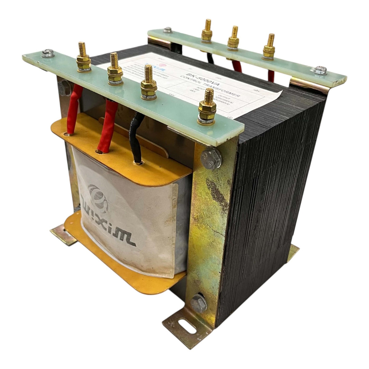 A heavy-duty industrial power transformer with a black textured core, brass terminal bolts, red and black wires, and a white paper insulation cover, isolated on a white background.