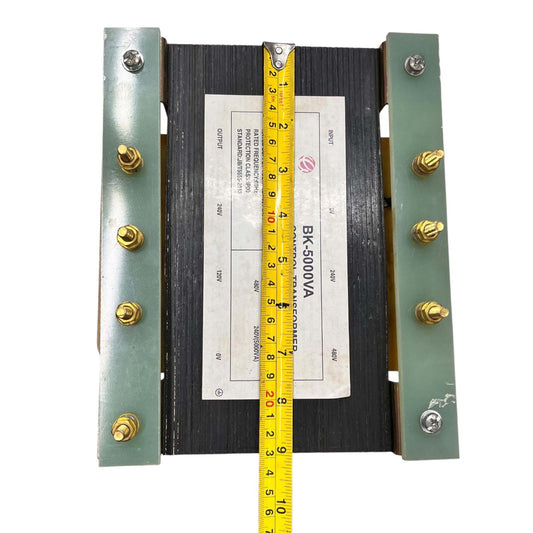 A large industrial electrical contactor rated BK 500VA, featuring a black central coil, green metal side plates with brass screws, and a yellow measuring tape vertically aligned to show its dimensions against a white background.