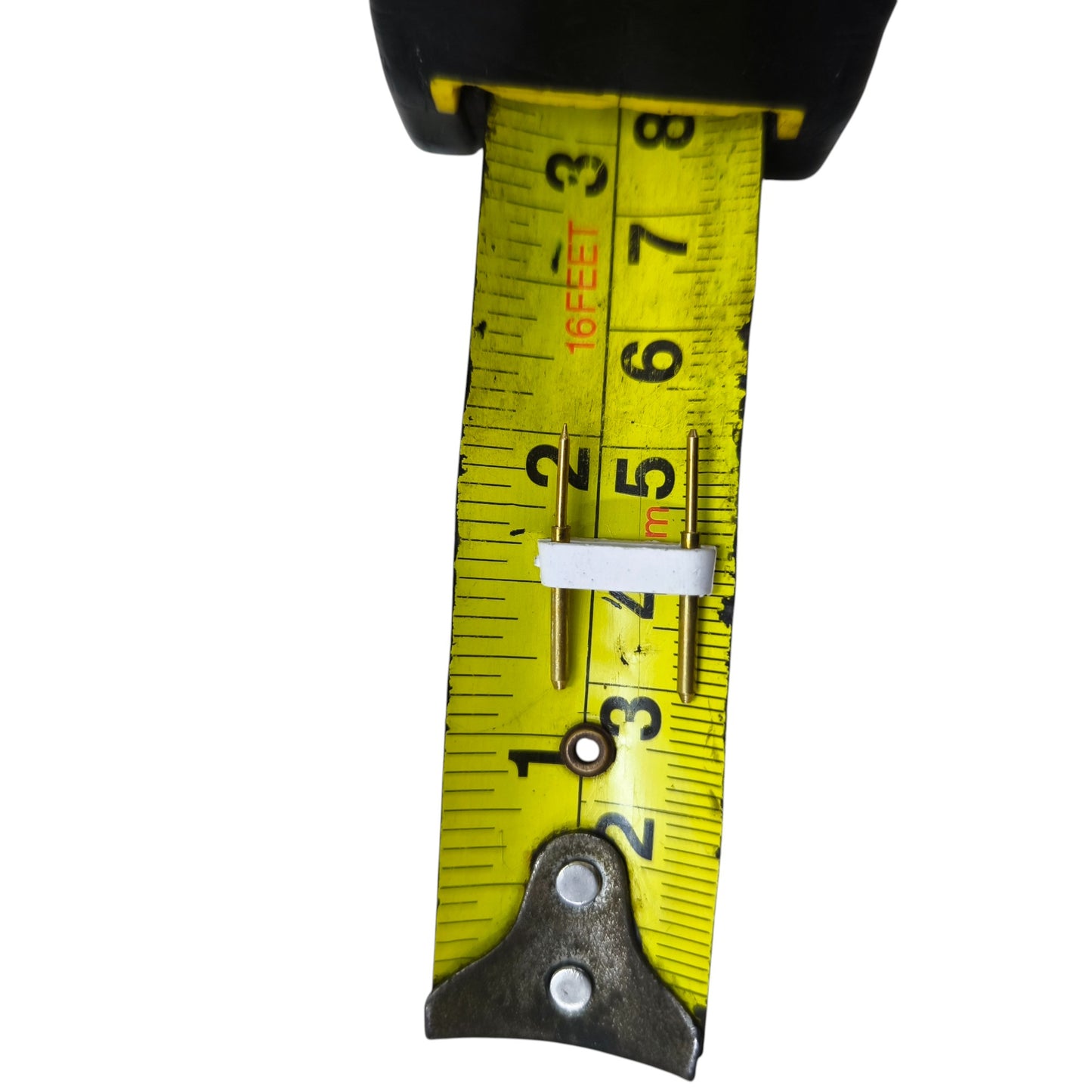 AC Pin 2 Pins for LED placed on yellow measuring tape showing size in inches