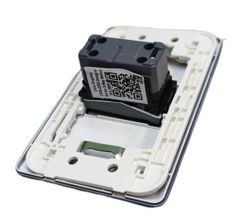 Omni 3 way switch graphite internal module in white wall plate showing QR code and mounting clips