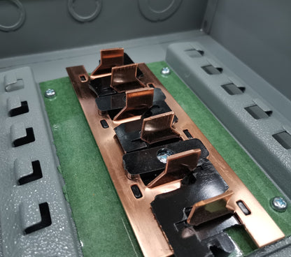 Close-up view of America 3x3 panel board 6 holes electrical circuitry and parts with copper connectors