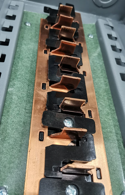 Panel board for 2 pole circuit breaker with copper connectors and mounting screws inside gray electrical box