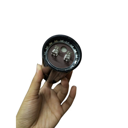 BMI 216-259MFD AC capacitor 250V held in hand showing terminal connections for electrical circuitry