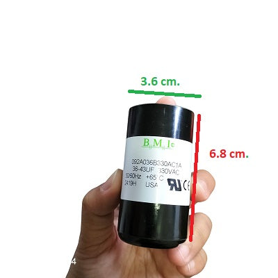 BMI Starting Capacitor 36-43 UF black cylindrical electrical component held in hand with label showing specifications