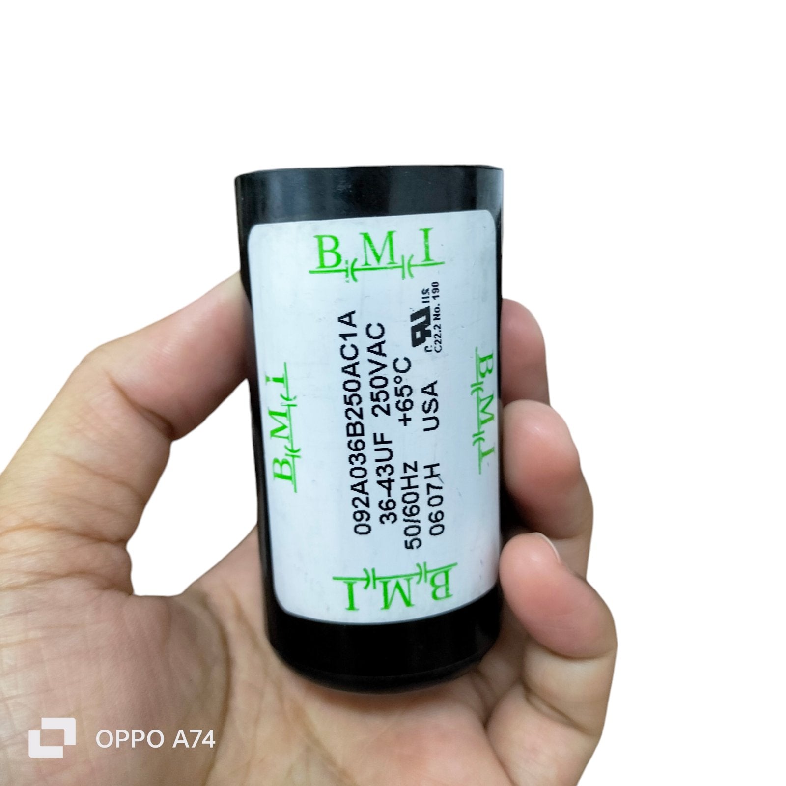 BMI Starting Capacitor 36-43 UF held in hand for electrical circuitry and parts