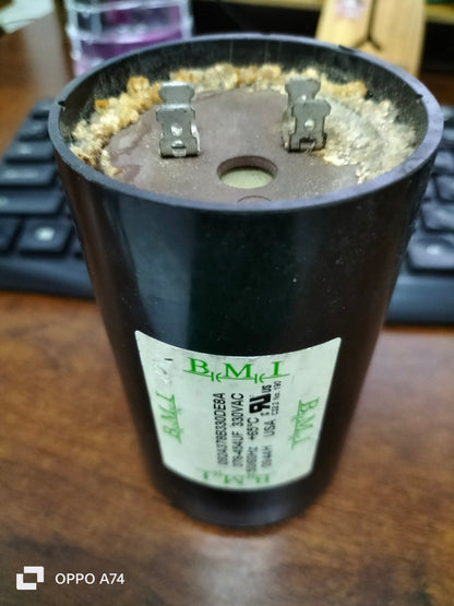 BMI starting capacitor 378-454UF black cylindrical electrical component with metal terminals