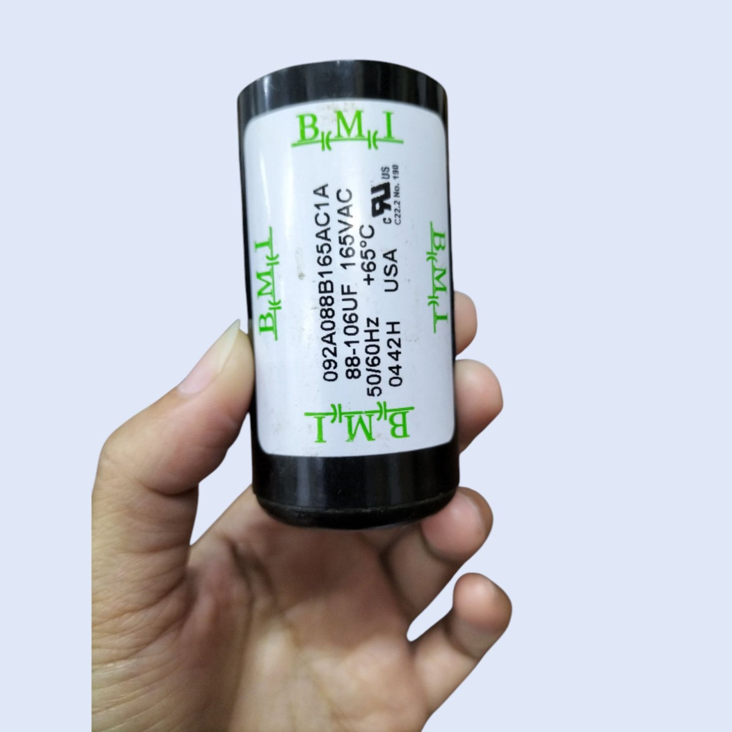 BMI 88-106MFD 165V AC motor capacitor in hand for electrical repairs