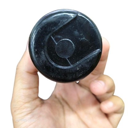 Hand holding Brand CDE 280-330 MFD 110-125V electrical circuitry part black cylindrical component