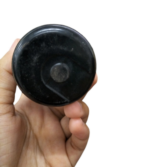 Hand holding a BMI Capacitor 324-388MFD 110-125V for electrical circuits