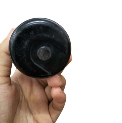 Hand holding a BMI Capacitor 324-388MFD 110-125V for electrical circuits