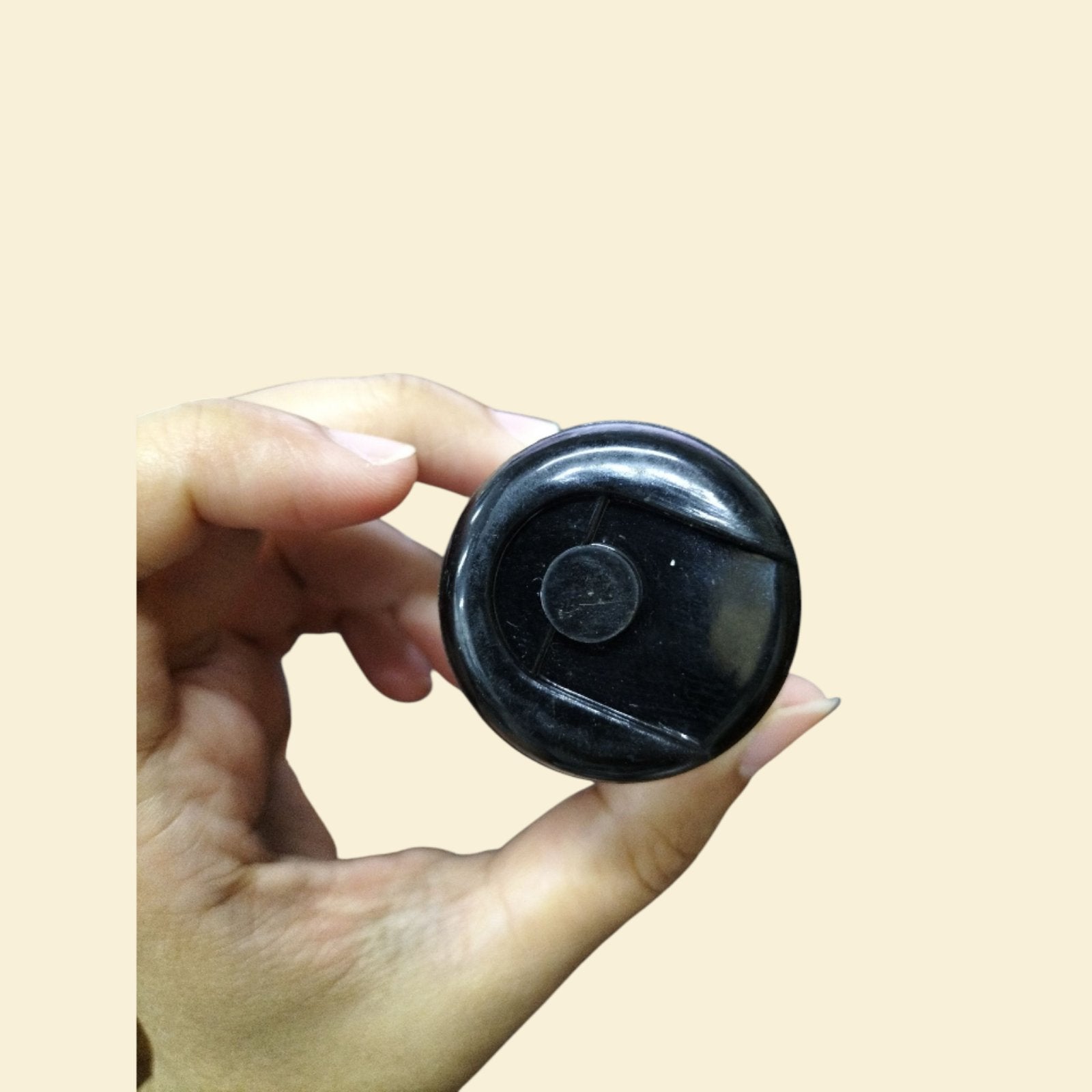 CDE electrical capacitor 110-125V held in hand showcasing its compact design