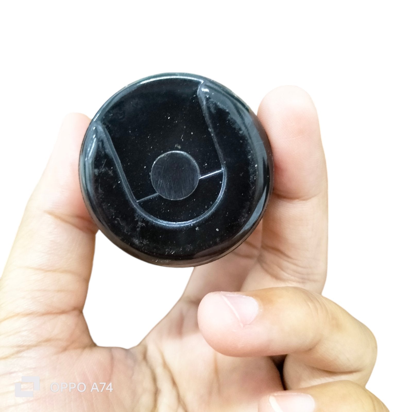 BMI Motor Starting Capacitor 270-324 UF held between thumb and finger for electrical circuitry