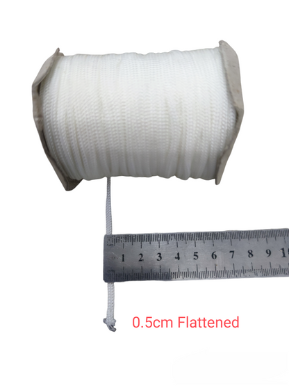 White cloth rope spool measured with a ruler showing 0.5cm flattened width Cloth Rope - Per Meter