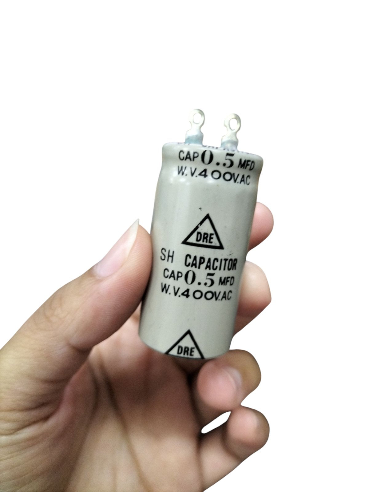 DRE 400V Motor Running Capacitor in a hand, ideal for enhancing motor performance and electrical efficiency