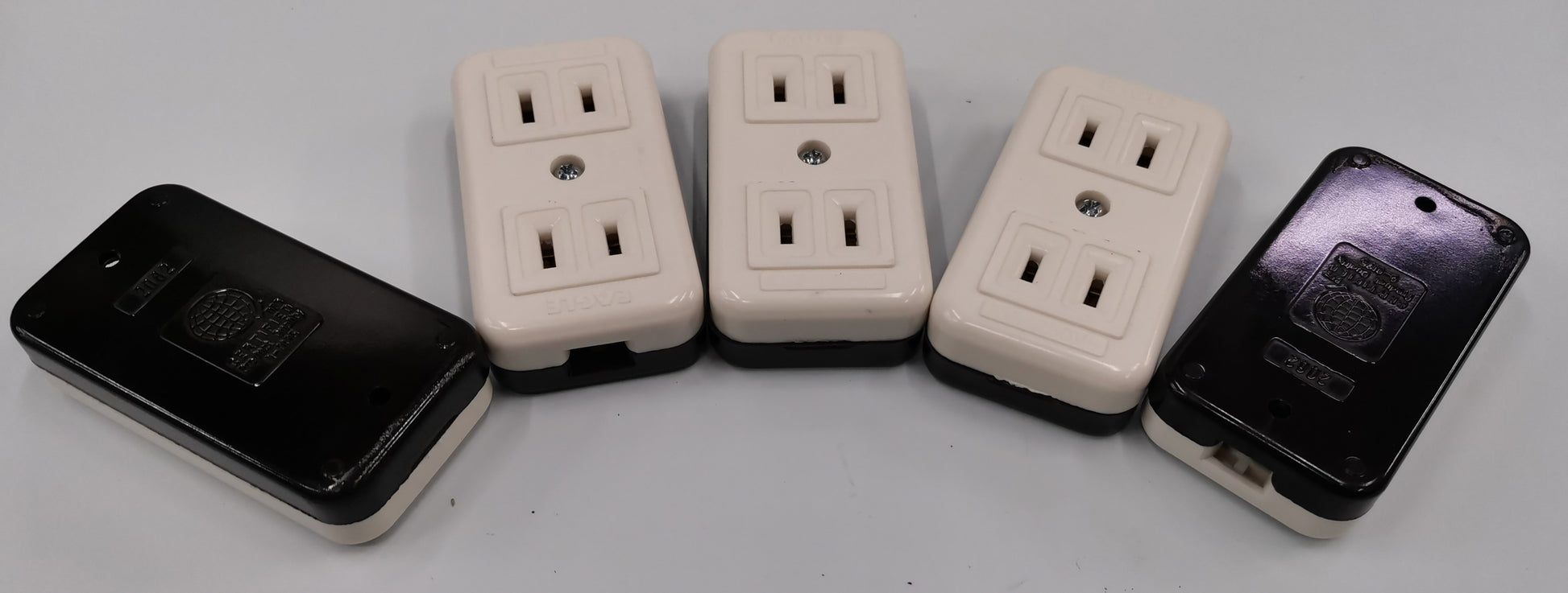 Eagle CAT2082 outlet adapter showing multiple white and black electrical outlet adapters for power points and plugs