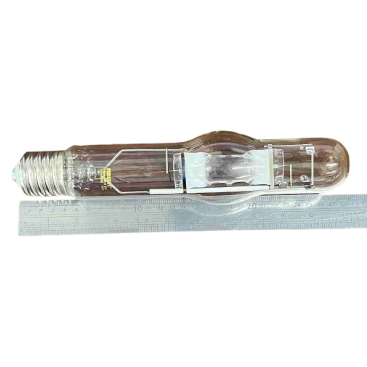 Light bulb with a ruler for scale on a white background
